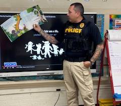 Officer Ernie Garcia reads to Northwest Elementary Students